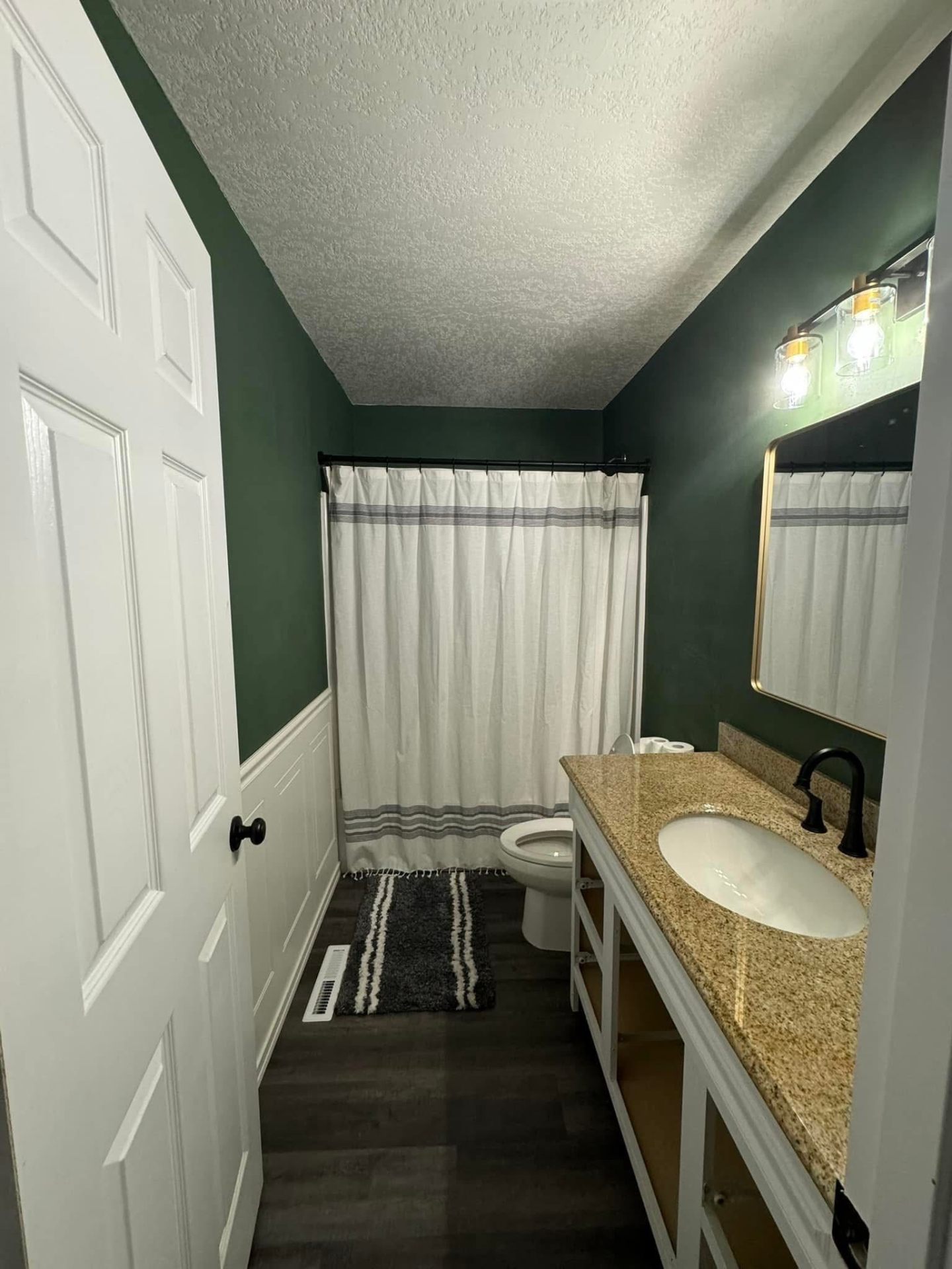 Bathroom with finished drywall, paint and trim