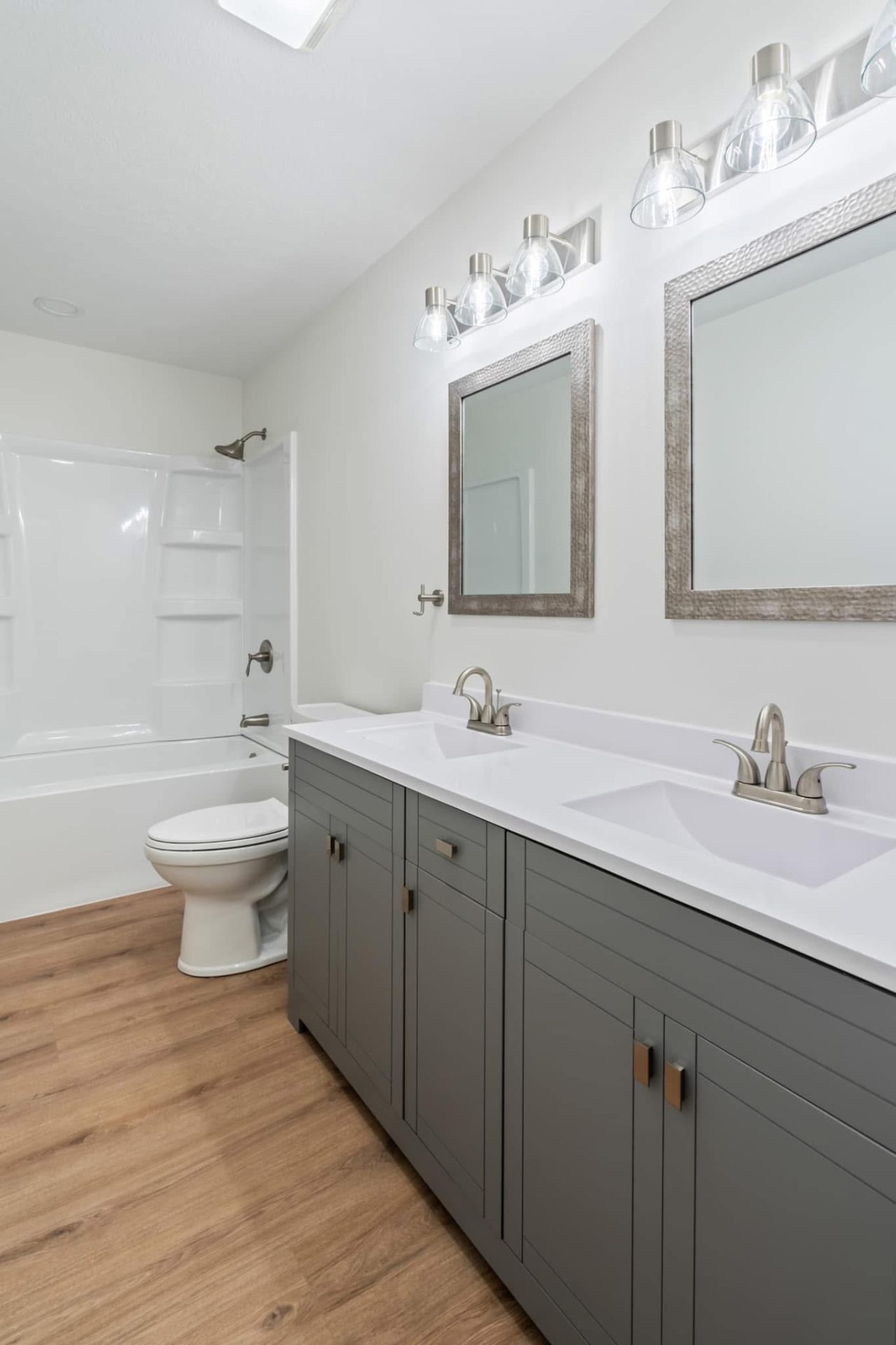 Finished bathroom with new drywall, vanity and tub surround